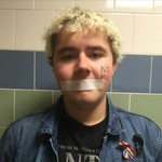 Riley Hogan - My name is Riley. I'm pansexual and agender and I use they/them pronouns. I've been harrassed for years for my gender, sexuallity, my religious opinions (atheist) and my race (half-irish, half Uruguayan) among other things. Discrimination is wrong and I want to see an end to it. The best part is that the school district wouldn't let us do the campaign last year because they felt that had implications of terrorism and ISIS because of the use of tape. I wish I was kidding. I don't want to hear anybody complain about political correctness after that because they have no idea what they are talking about. I have been accused of supporting it by ignorant people who think that silencing minorities is somehow not politically correct. I implore them to read a dictionary. While our GSA had a creative solution to this, which indulged in for a nice picture in the school newspaper, me and a friend did it the normal way in the school's only unisex bathroom (discounting the nurse's office) as an act of defiance. If participating in a non-violent, peaceful protest to support the fair treatment of LGBT+ people makes me some kind of villain, then I don't think I'm evil enough. While I don't want any trouble, I hope I do in a way so that I can expose the problems with the administration.